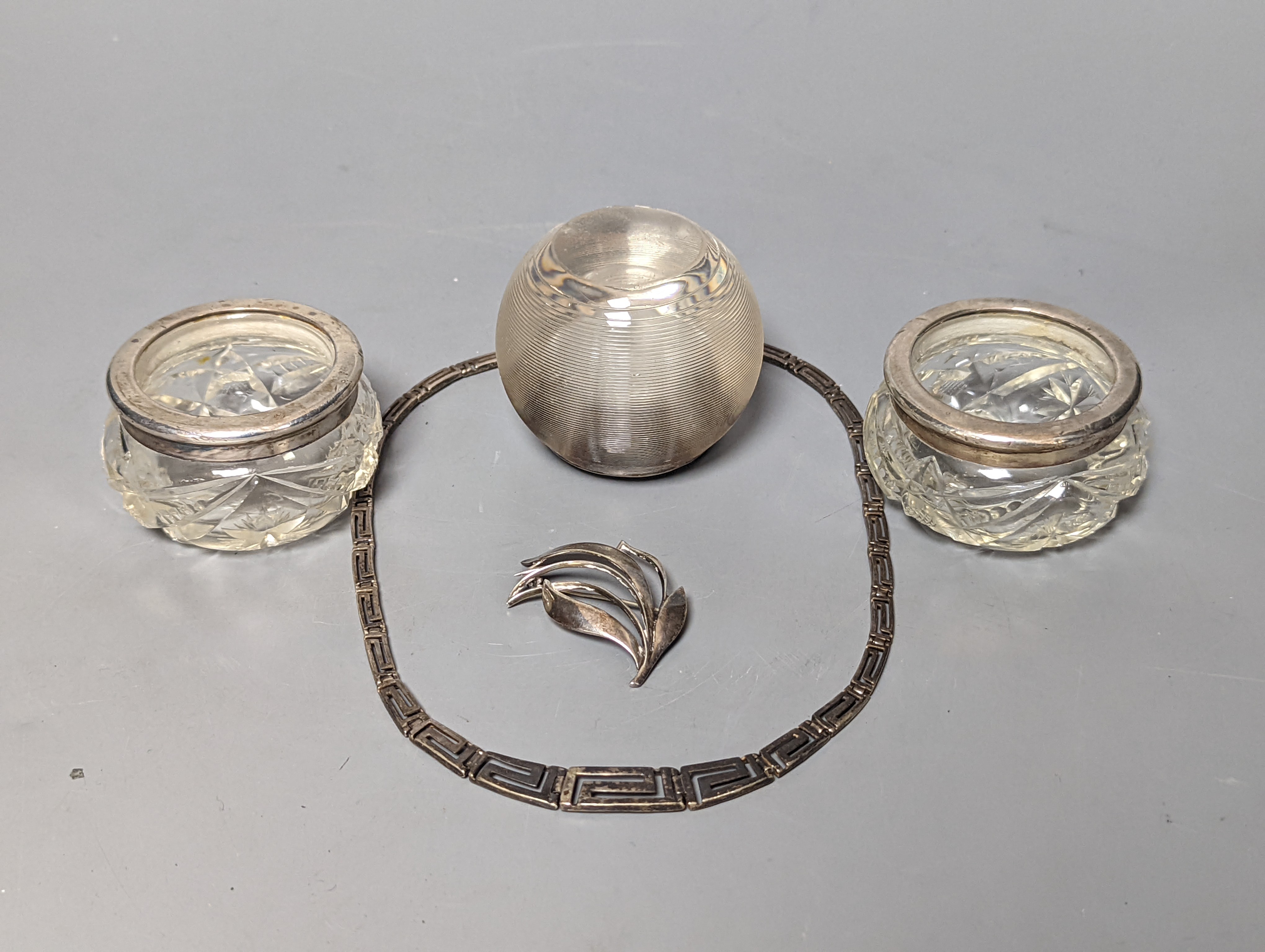 A Danish sterling foliate brooch, 5cm, a 925 'Greek Key' necklace and three silver mounted glass items including an early 20th century match tidy.